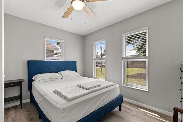a bedroom with a bed a chandelier and window