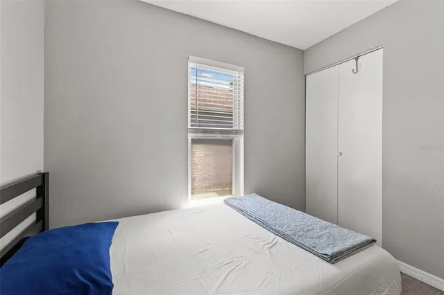 a bedroom with a bed and a window