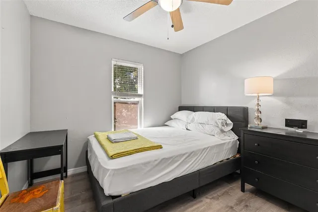 a bedroom with a bed and a desk