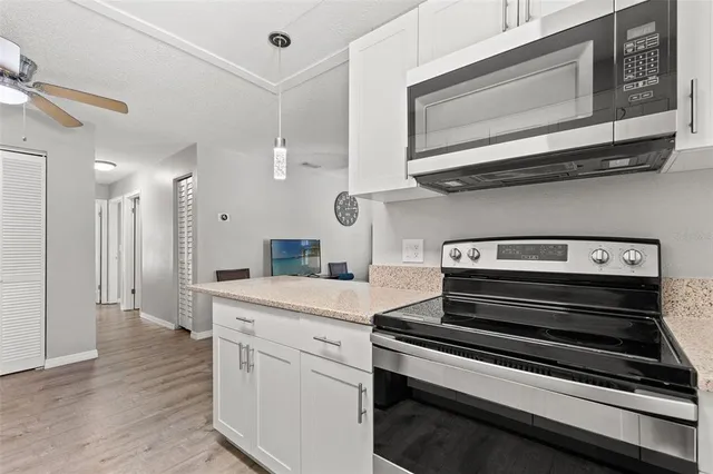 a kitchen with a stove and a microwave