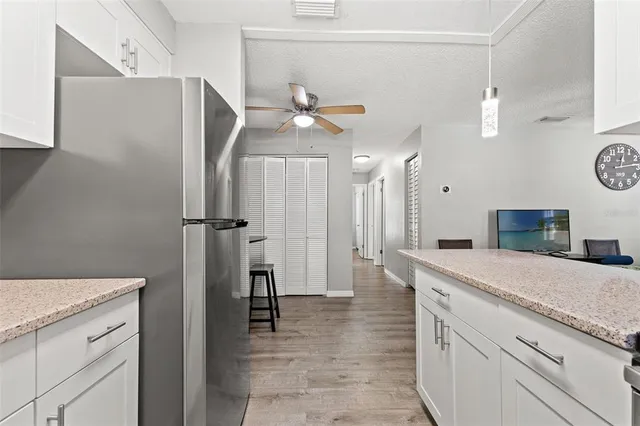 a spacious bathroom with a granite countertop sink a toilet and a mirror