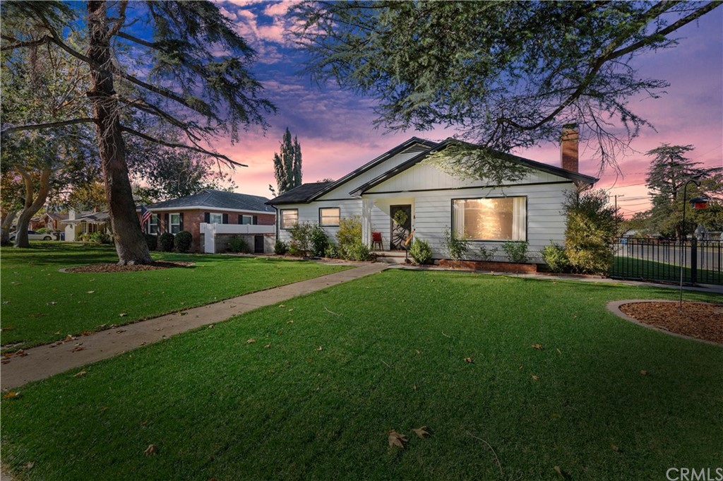 5421 Alden Road Riverside, CA 92506 - Photo 1 of 1 a front view of a house with a garden and trees