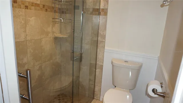 a bathroom with a toilet and a shower