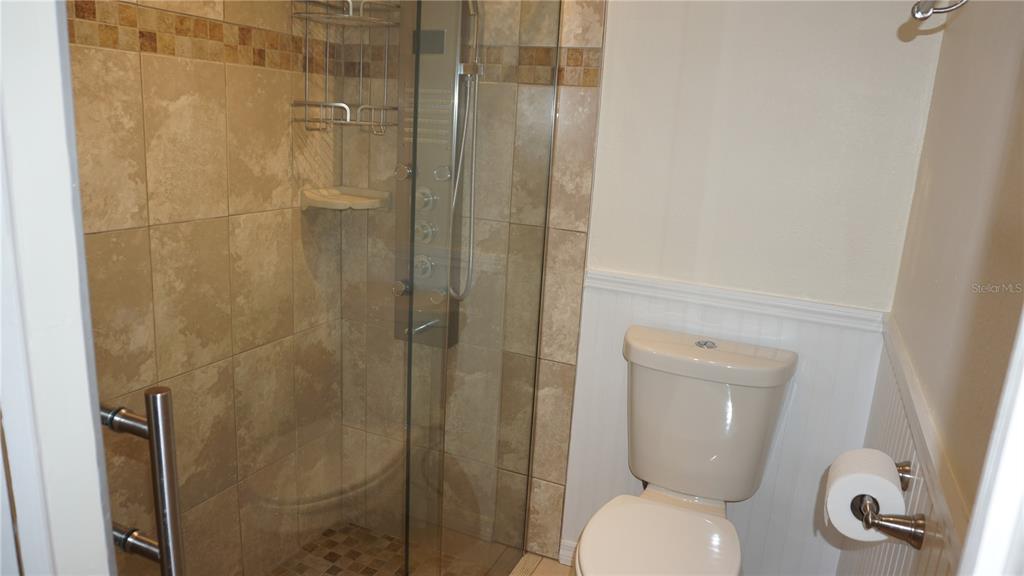 7602 Danube Drive, Unit 7602 Hudson, FL 34667 - Photo 11 of 31 a bathroom with a toilet and a shower