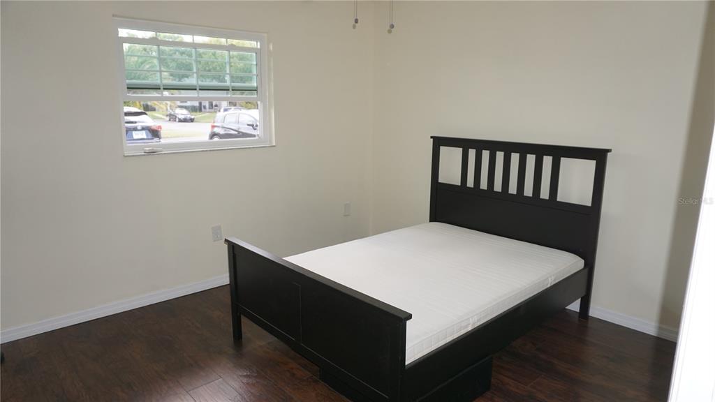 7602 Danube Drive, Unit 7602 Hudson, FL 34667 - Photo 15 of 31 a bed sitting in a bedroom next to a window