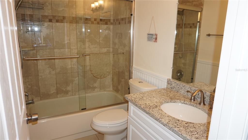 7602 Danube Drive, Unit 7602 Hudson, FL 34667 - Photo 16 of 31 a bathroom with a granite countertop sink toilet and shower