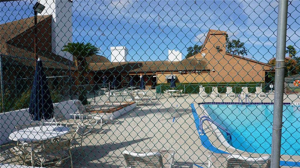 7602 Danube Drive, Unit 7602 Hudson, FL 34667 - Photo 28 of 31 a view of a patio with table and chairs potted plants