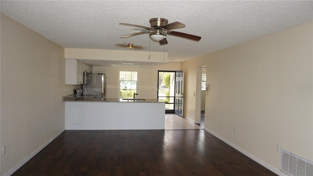 7602 Danube Drive, Unit 7602 Hudson, FL 34667 - Photo 7 of 31 a view of empty room with wooden floor and fan