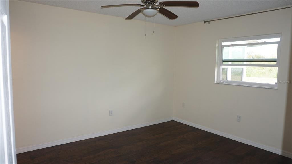 7602 Danube Drive, Unit 7602 Hudson, FL 34667 - Photo 9 of 31 an empty room with a window and a fan