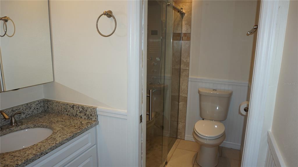 7602 Danube Drive, Unit 7602 Hudson, FL 34667 - Photo 10 of 31 a bathroom with a granite countertop sink toilet and shower