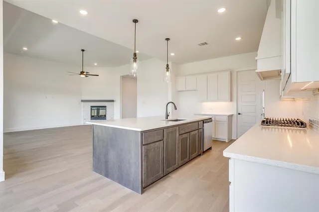 a large kitchen with stainless steel appliances lots of counter top space
