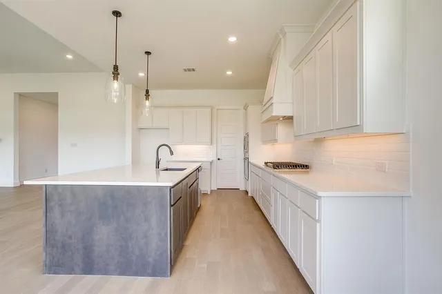 a kitchen with granite countertop a stove and a sink