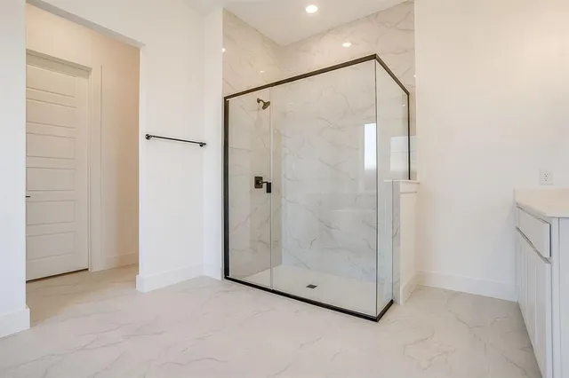 a bathroom with a glass shower door