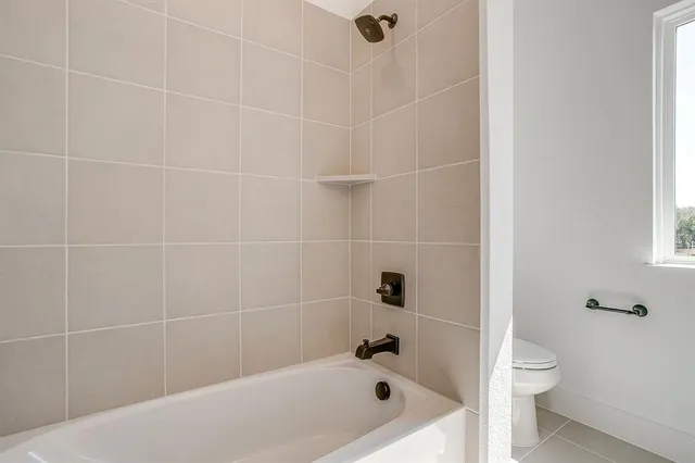 a bathroom with a bathtub and a toilet
