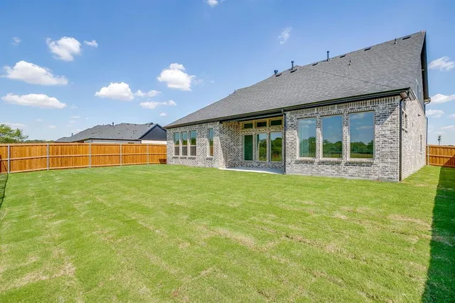 a view of a house with a garden and yard