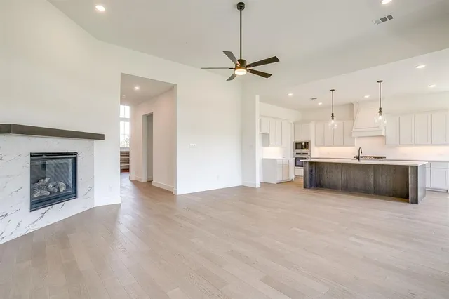 a view of a kitchen with a sink and a fireplace