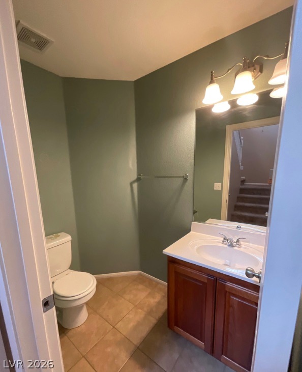 10841 Paradise Road Henderson, NV 89052 - Photo 29 of 35 Functional bathroom features a simple vanity, mirror, and toilet, offering practical use.