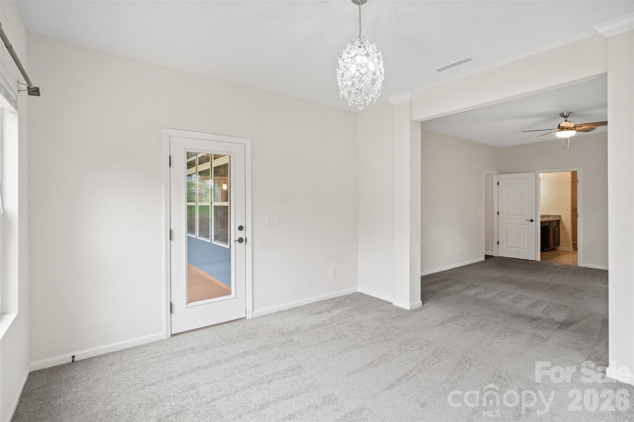 5299 Admirals Landing Lancaster, SC 29720 - Photo 12 of 39 an empty room with chandelier and windows