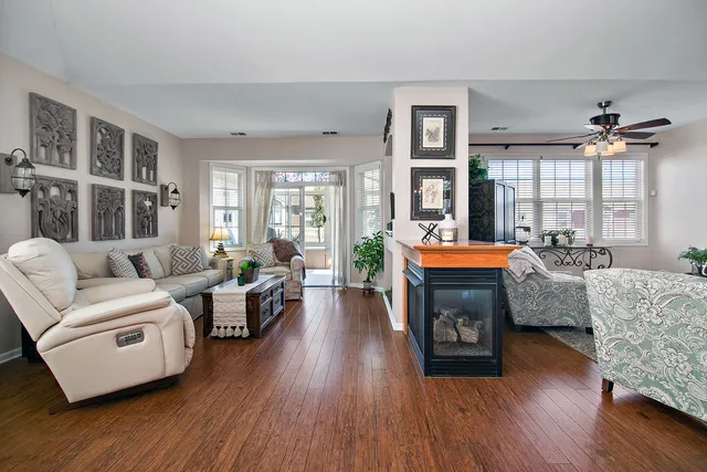 a living room with furniture and a fireplace