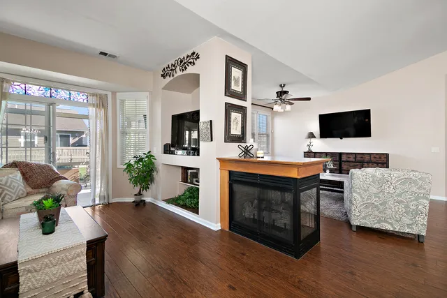 a living room with furniture a fireplace and a flat screen tv