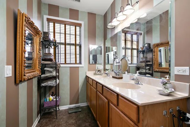 a bathroom with a sink double vanity and a mirror