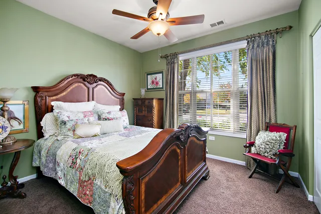 a bedroom with a bed couch and window