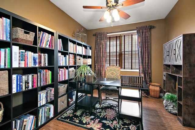 a living room with furniture a book shelf and a book shelf