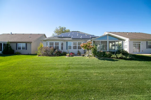 a front view of a house with a garden and plants
