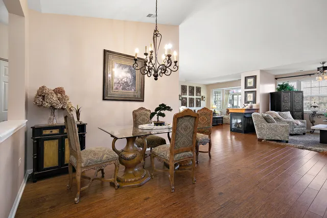 a view of a dining room with furniture wooden floor and chandelier