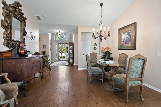 a view of a dining room with furniture wooden floor and chandelier