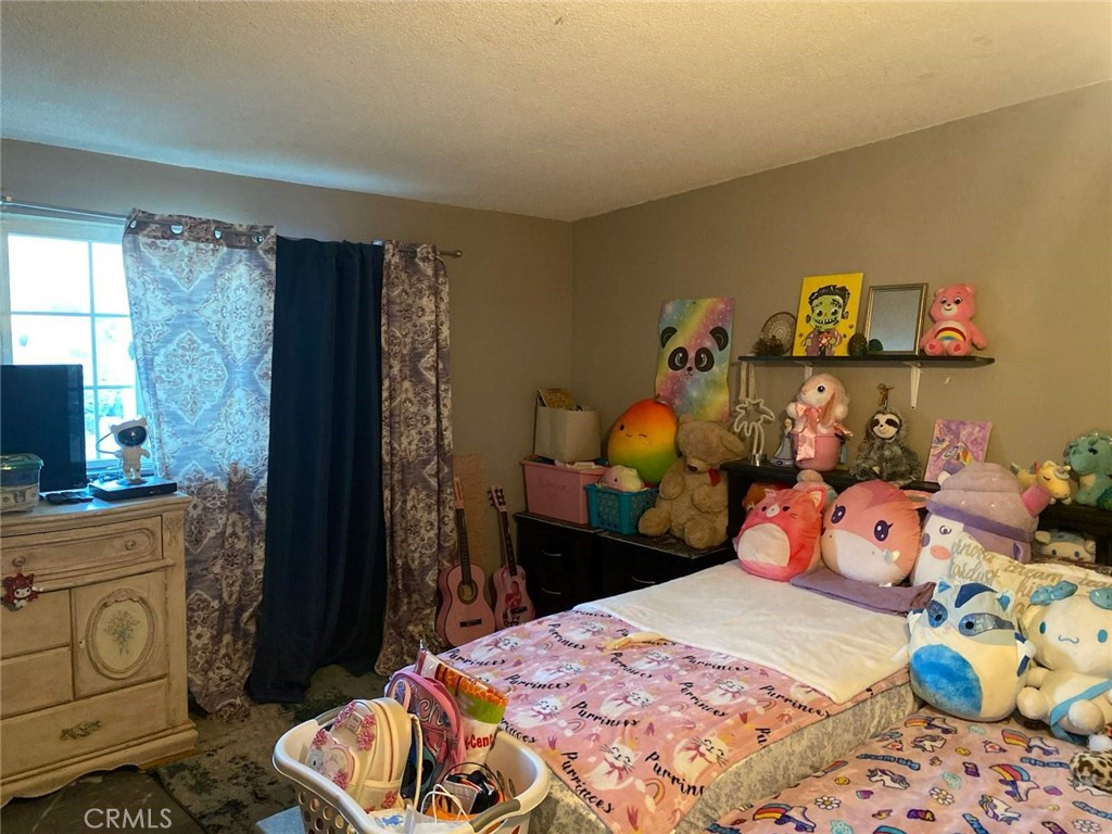 13391 Mesquite Road Whitewater, CA 92282 - Photo 12 of 17 a bedroom with a bed and wooden floor