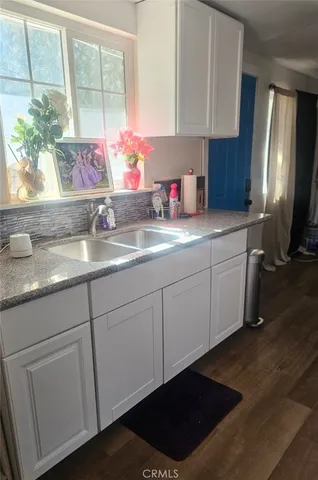 a kitchen with a sink cabinets and a window
