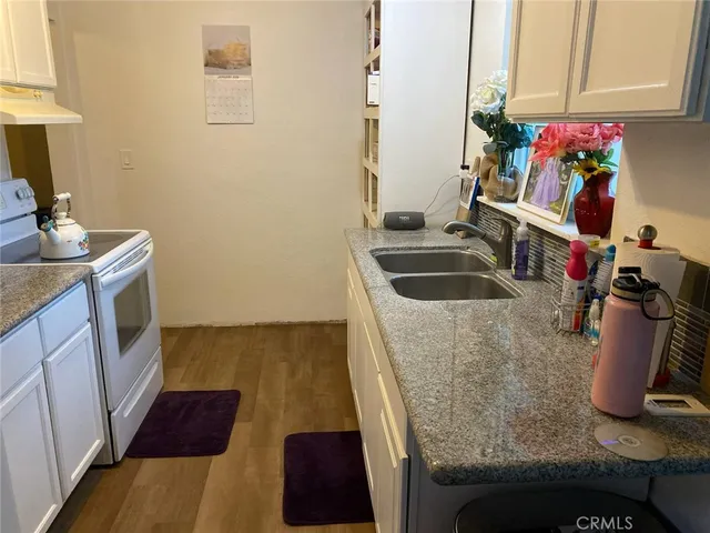 a kitchen with a sink and a stove top oven