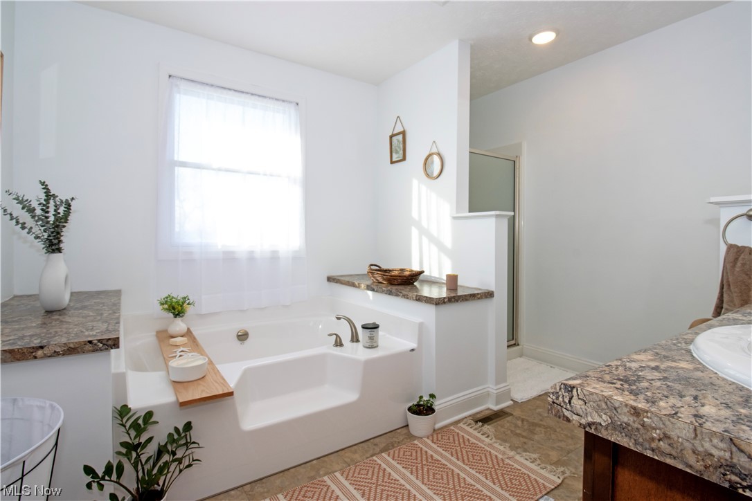 4750 McCauley Road Wooster, OH 44691 - Photo 28 of 37 Bathroom featuring separate shower and tub, vanity, and tile flooring