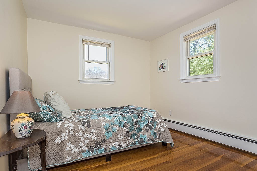 17 George Road, Unit 17 Winchester, MA 01890 - Photo 15 of 19 a bedroom with a bed and wooden floor