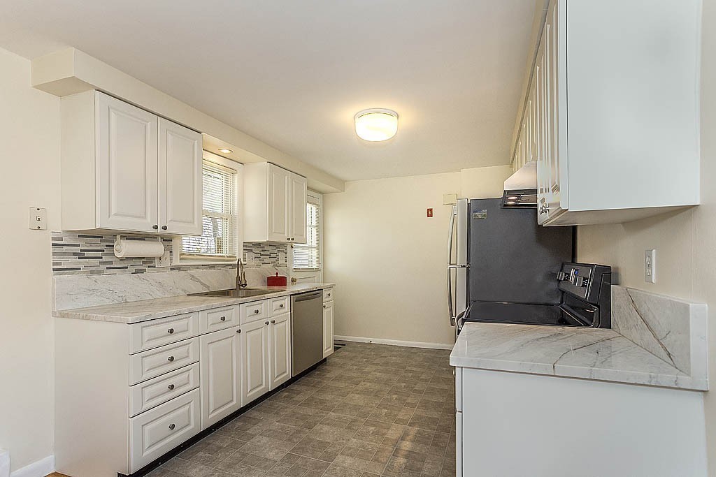 17 George Road, Unit 17 Winchester, MA 01890 - Photo 8 of 19 a kitchen with appliances a sink and cabinets