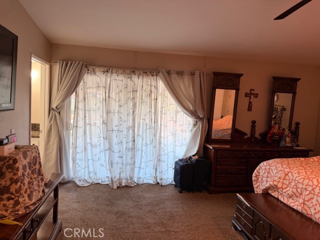 24410 Rimview Road Moreno Valley, CA 92557 - Photo 12 of 27 a living room with a bed furniture and a large window
