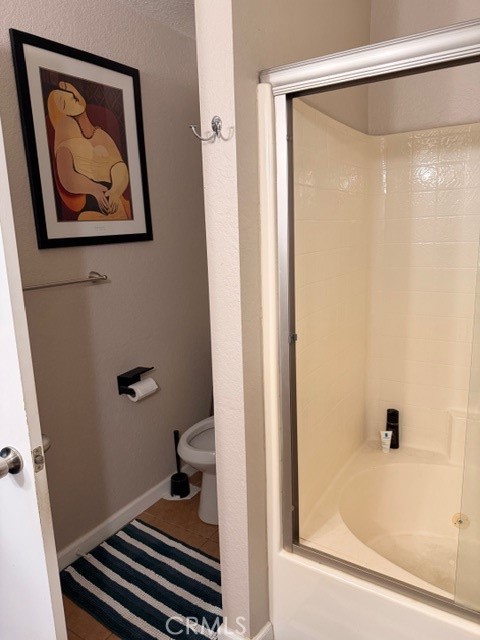 24410 Rimview Road Moreno Valley, CA 92557 - Photo 14 of 27 a bathroom with a shower and a toilet