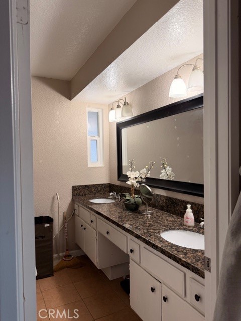 24410 Rimview Road Moreno Valley, CA 92557 - Photo 17 of 27 a bathroom with sink and mirror