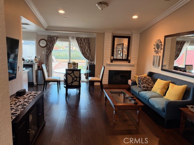 24410 Rimview Road Moreno Valley, CA 92557 - Photo 6 of 27 a living room with furniture a fireplace wooden floor and a large window