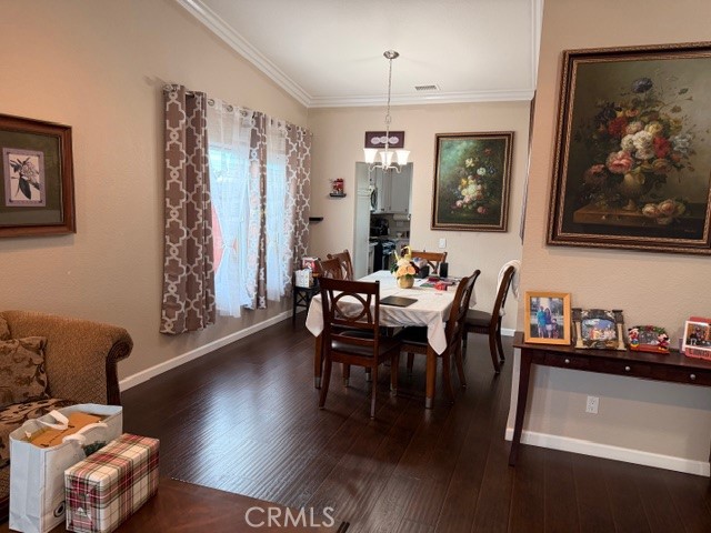 24410 Rimview Road Moreno Valley, CA 92557 - Photo 7 of 27 a view of a dining room with furniture window and wooden floor