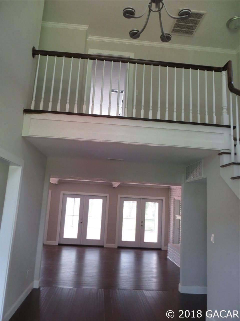 3510 Southwest 63rd Lane Gainesville, FL 32608 - Photo 2 of 13 Entryway looking through to great room. Stairs on the right, living room to the left.
