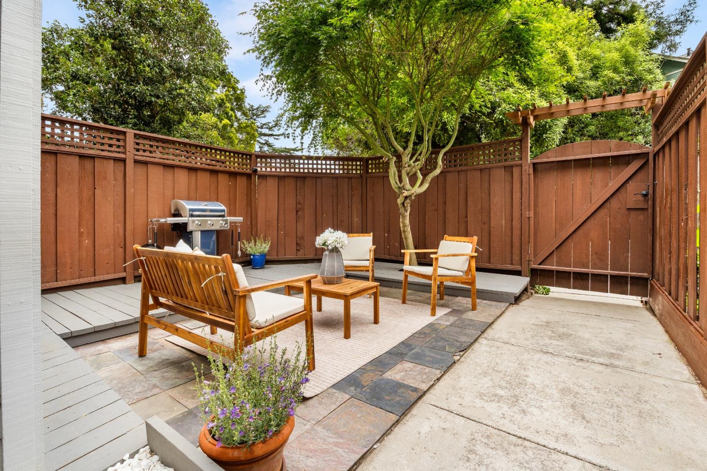 1644 Ocean Street Santa Cruz, CA 95060 - Photo 3 of 60 a backyard of a house with table and chairs