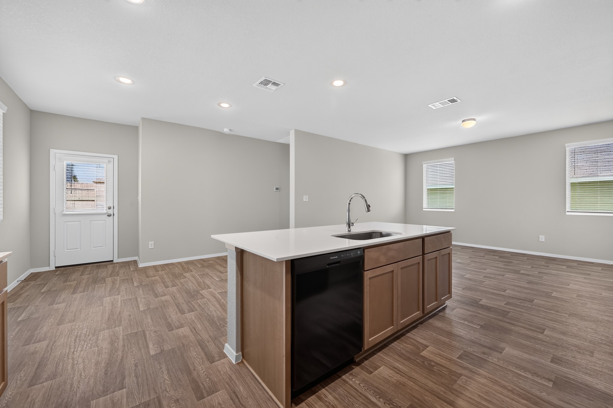 2704 Towy Road Manor, TX 78653 - Photo 5 of 36 Gleaming wood-look floors anchor this airy open concept kitchen and living area.
