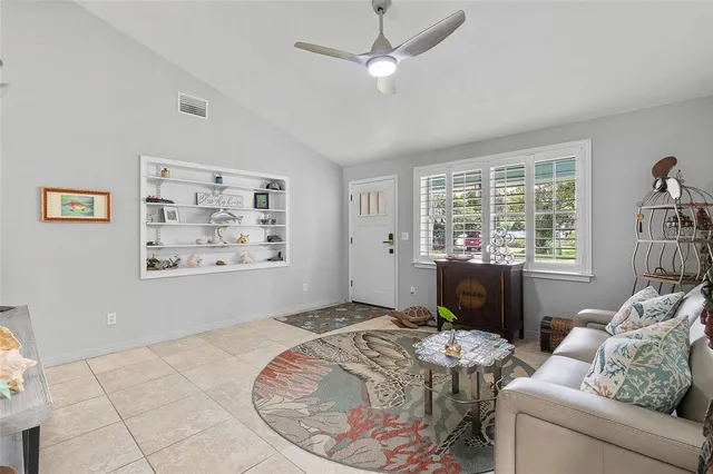 a kitchen with a dining table chairs sink and wooden floor