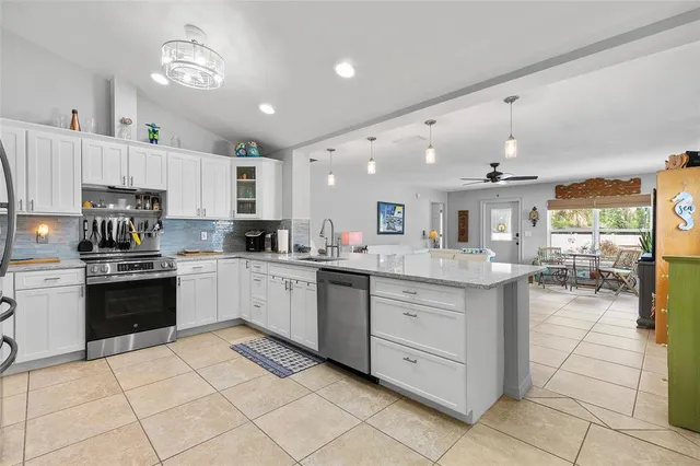 a kitchen with stainless steel appliances granite countertop a refrigerator and a sink