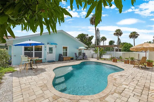 a view of a swimming pool with lounge chairs