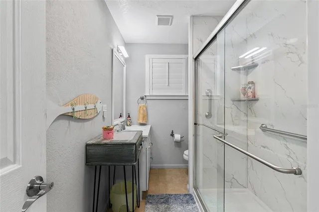 a bathroom with a toilet and a shower