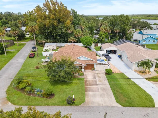 an aerial view of residential house with outdoor space and swimming pool