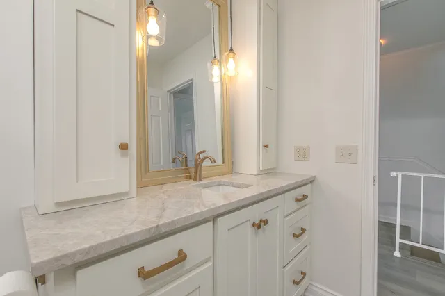 a bathroom with a sink and a mirror